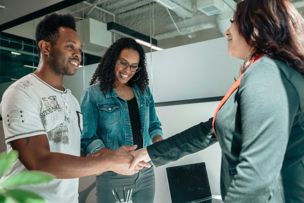 Man and woman shaking hands with a female attorney